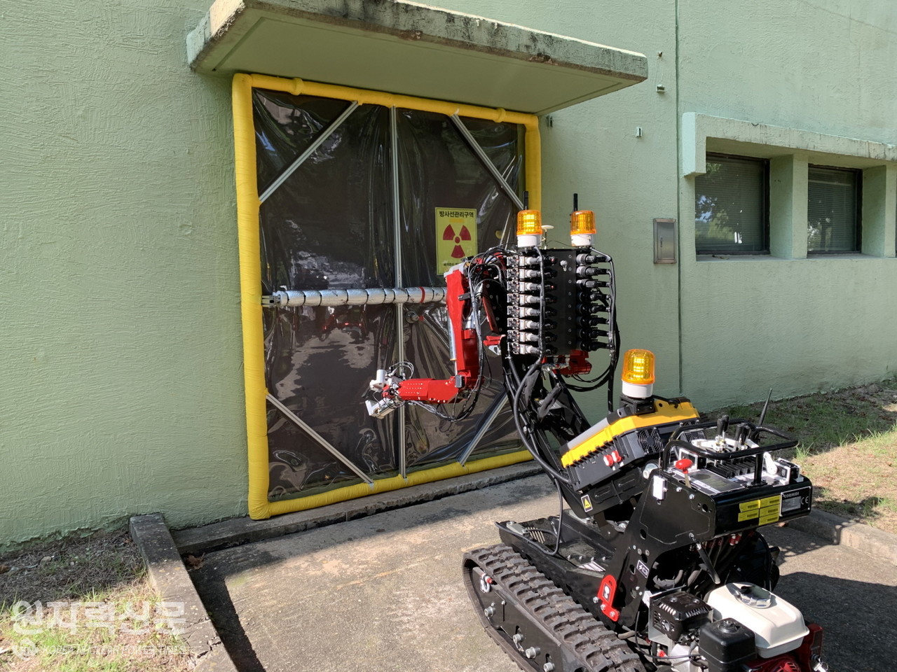 원자력연구원이 개발한 암스토롱 로봇이 차폐막을 설치하고 있는 장면.