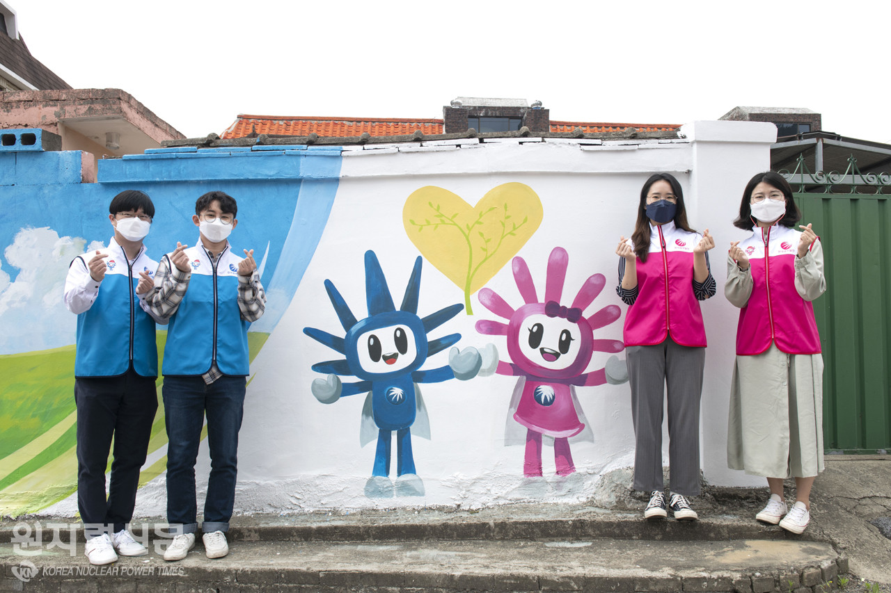한국중부발전 직원들이 새단장된 벽화 앞에서 기념촬영을 하고 있다.